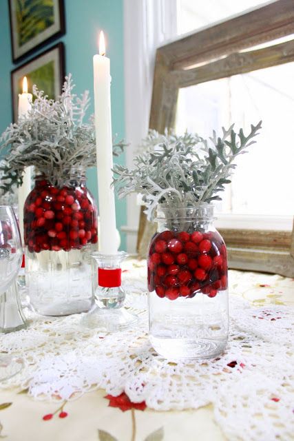"The centerpieces are just Mason Ball jars that I filled with water, dumped fresh cranberries in, and then stuffed with Dusty Miller from my front garden." Could use vases