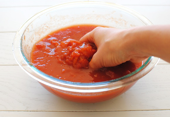 Crush the tomatoes with your hands.
