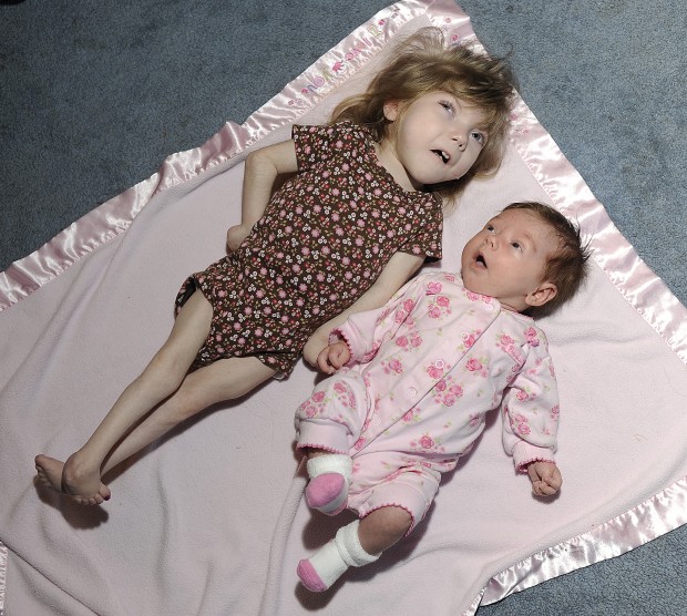 Gabby Williams shares a blanket with her baby sister
