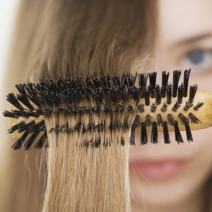 Close up of hairbrush in woman?s hair