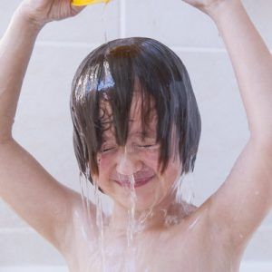 Girl washing her hair in bath